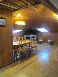 a dining room with a wooden table and chairs at Ático Yuly in Rianjo +14 photos