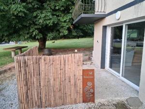 a wooden fence in front of a building at Chez vous in Dirinon