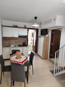 a kitchen and dining room with a table and chairs at B&B Vuiariello in Montefusco