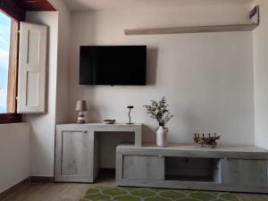 a living room with a tv on a wall at B&B Vuiariello in Montefusco