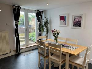 a dining room with a table and chairs and a window at Pebble Reef in Portland