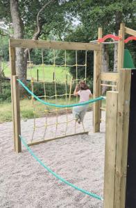 a woman is jumping on a playground at Domaine Ecoline in Sadirac
