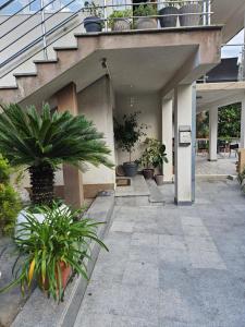 a building with potted plants on the side of it at Villa primorka in Boreti