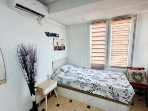 a small bedroom with a bed and a window at Casa Carlos de Novelda in Novelda