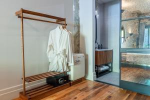 a white robe hanging on a rack in a room at Sela V Hotel in Brooklyn +37 photos