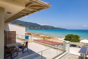 a view of the beach from the balcony of a house at Kastalia Studios And APARTMENTS in Skala Potamias