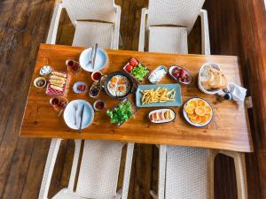 a tray of food on a table with plates of food at Izgen Bungalows in Cıralı +41 photos