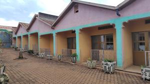 a row of buildings on a brick street at Life Vision Hotel in Huye
