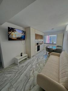 a living room with a couch and a table at Apartament Deluxe in Orăştie