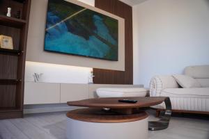 a living room with a coffee table and a couch at Lakeside Palms in Tirana