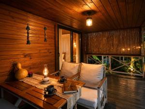a wooden room with a table and a couch and a table sidx sidx at Izgen Bungalows in Cıralı