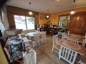 a living room with a table and chairs at Alojamientos Fermín in Cangas de Onís