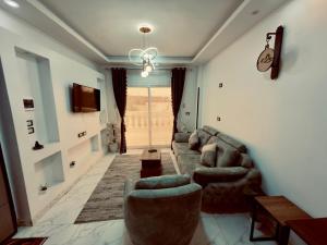 a living room with couches and a chandelier at private studio - djorff area in Al Aqālitah +14 photos