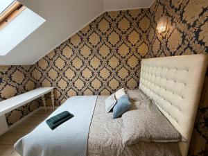 a bedroom with a bed with a white headboard at Glow Rooms in Gdynia