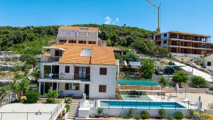 a house with an orange roof and a swimming pool at Rezidence Castello in Korčula