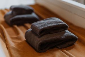 a pile of black towels sitting on top of a table at Buntes nams l Self check-in l Private entrance in Limbaži +88 photos