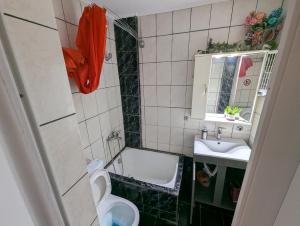 a small bathroom with a toilet and a sink at Angel Room 2 in Nea Plagia
