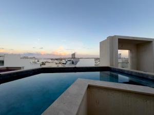 a swimming pool on the roof of a building at Eva's Penthouse with private Swimming pool by ELDI in Il-Gżira
