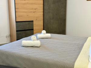 two towels sitting on top of a bed at Eva's Penthouse with private Swimming pool by ELDI in Il-Gżira +37 photos