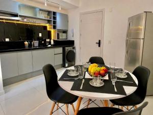 a kitchen with a table with a bowl of fruit on it at Maxplaza Residential 1209 in Canoas