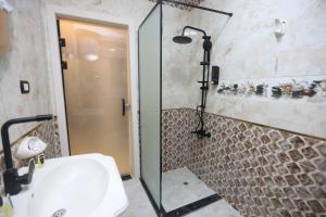 a bathroom with a shower and a white sink at Sacred Pyramids Stay in Cairo +127 photos