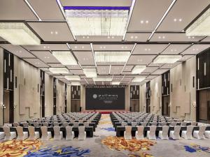 a large room with chairs and a projection screen at Pullman Huai'an in Huai'an +72 photos