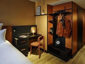 a bedroom with a bed and a desk and a chair at Tribe Paris Saint Ouen in Saint-Ouen