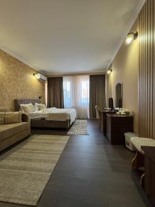 a hotel room with a bed and a desk at Hotel COLISEUM in Calafat +33 photos