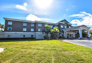 a large building with a lawn in front of it at Holiday Inn Express & Suites Cocoa by IHG in Cocoa