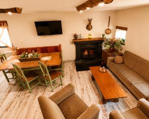 a living room with a table and a fireplace at Casa Rural Pablo in Ara