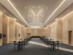 a large room with tables and chairs in it at SO/ Uptown Dubai in Dubai +140 photos