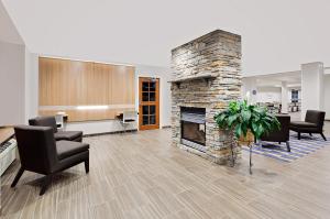 a lobby with a stone fireplace in a office at Microtel Inn & Suites by Wyndham Middletown in Middletown