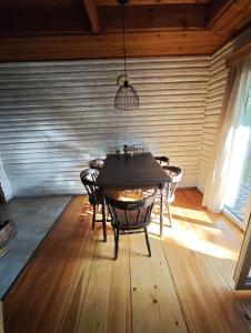 a dining room with a table and chairs at Chata Radostín in Radostín +16 photos