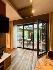 a living room with a sliding glass door with a table at Desimo Home in Piła