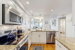 a kitchen with white cabinets and a counter top at Sea Colony - 604 Dover House Rd. in Bethany Beach