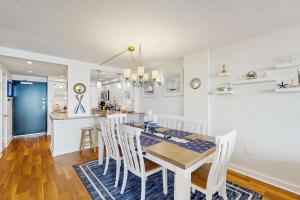 a dining room and kitchen with a table and chairs at Sea Colony - 604 Dover House Rd. in Bethany Beach