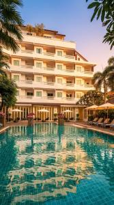 a large swimming pool in front of a hotel at Hill Fresco Hotel in Pattaya South