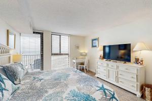 a bedroom with a bed and a flat screen tv at Sea Colony - 604 Dover House Rd. in Bethany Beach