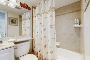 a bathroom with a toilet and a shower curtain at Sea Colony - 604 Dover House Rd. in Bethany Beach +28 photos
