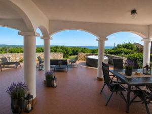 a patio with a table and chairs and a view at Dorono House in Balatonudvari