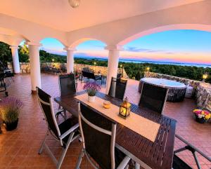 a patio with a table and chairs with a view at Dorono House in Balatonudvari