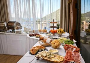 a buffet of food on a table in a room at Azzurro Vista in Budva