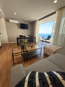 a living room with a couch and a table at Seba Deluxe Home in Puerto de Santiago