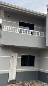 a gray house with a balcony and a door at Apto 013 - Residencial Canaã in Porto Velho