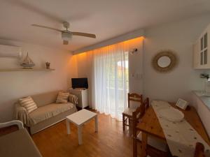 a living room with a couch and a table at Irini Seaside Apartment in Paleo Tsifliki