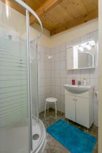 a bathroom with a shower and a sink at Artemida House in Artemida