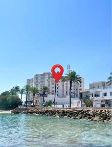 a red heart sign on a beach near the water at Appartement S3 in Mahdia in Mahdia