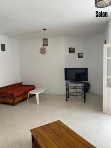 a living room with a couch and a tv at Appartement S3 in Mahdia in Mahdia