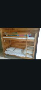 a wooden bunk bed with four bunk beds at Casse blanche in Orcières