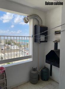 a room with a balcony with a view of the beach at Appartement S3 in Mahdia in Mahdia